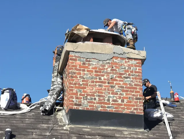 Tamiami Chimney Sweep installing a custom chimney crown in Tamiami, FL